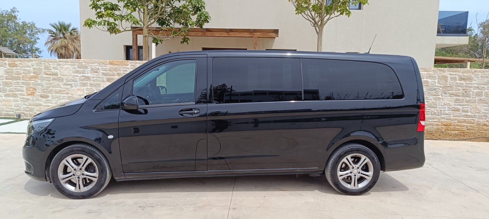 Side profile of the black Mercedes V-Class in Crete